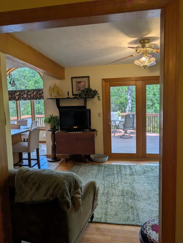 249 Mount Vernon Rd, Forsyth, MO 65653 - living room featuring a textured ceiling, ceiling fan, and wood finished floors
