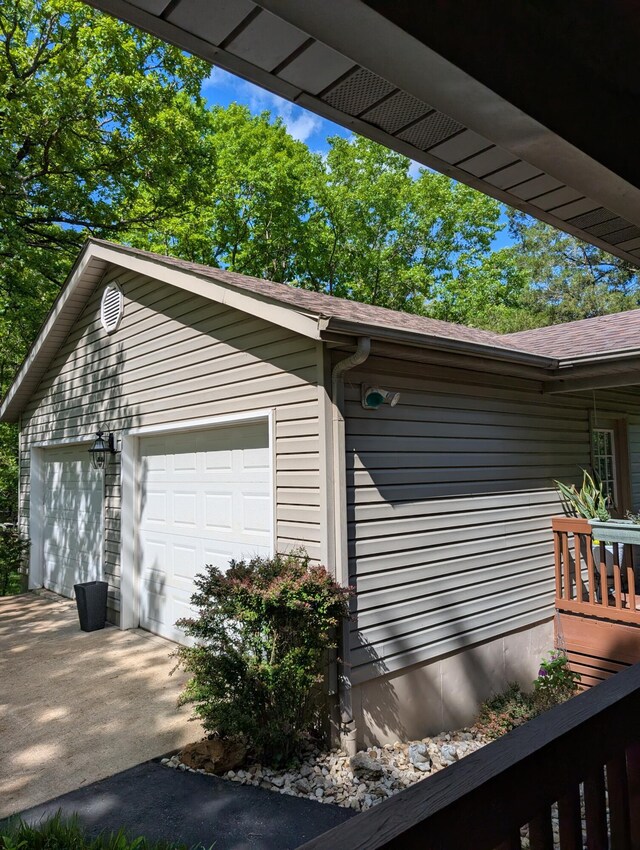 249 Mount Vernon Rd, Forsyth, MO 65653 - view of property exterior with a garage, roof with shingles, driveway, and an outbuilding