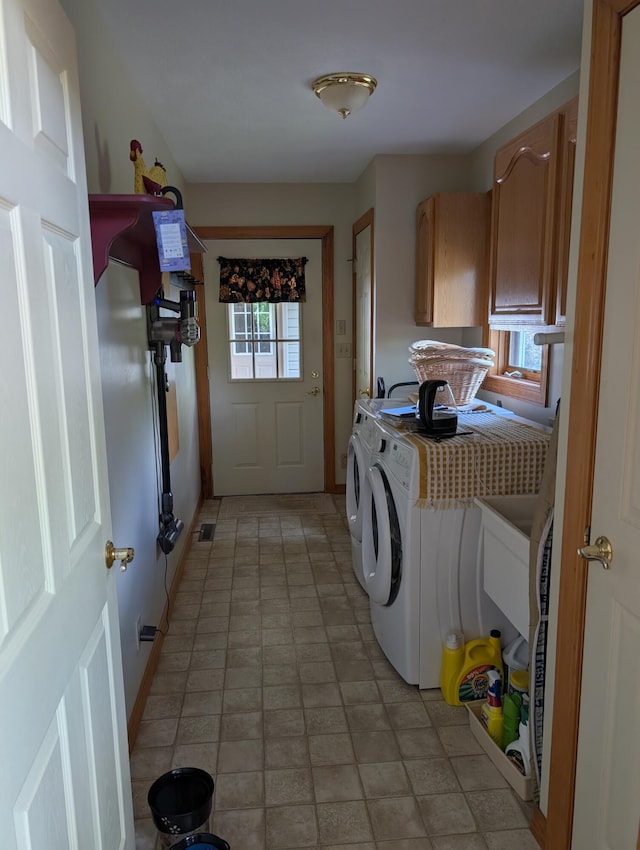 249 Mount Vernon Rd, Forsyth, MO 65653 - clothes washing area featuring baseboards, cabinet space, and washer and clothes dryer