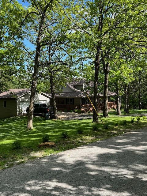 249 Mount Vernon Rd, Forsyth, MO 65653 - view of front of house with an attached garage and a front lawn