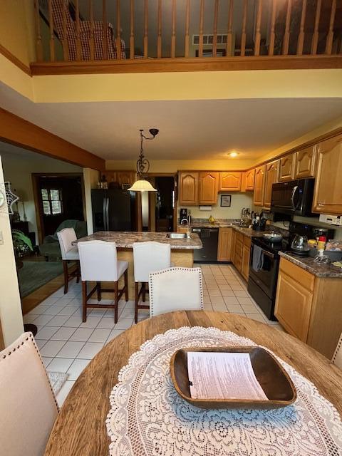 249 Mount Vernon Rd, Forsyth, MO 65653 - kitchen with a towering ceiling, light tile patterned floors, and black appliances