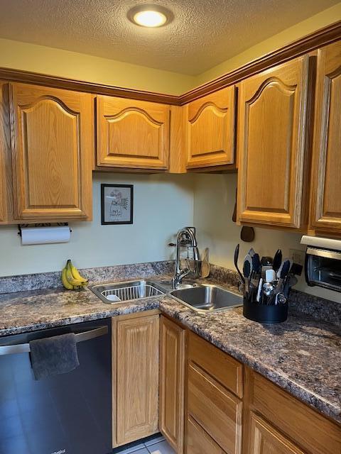 249 Mount Vernon Rd, Forsyth, MO 65653 - kitchen featuring a sink, brown cabinets, a textured ceiling, and dishwasher