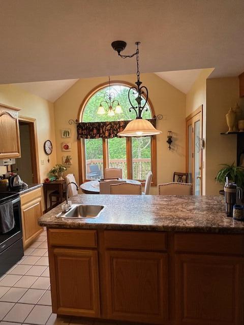 249 Mount Vernon Rd, Forsyth, MO 65653 - kitchen featuring black range with electric cooktop, a sink, light tile patterned floors, vaulted ceiling, and decorative light fixtures