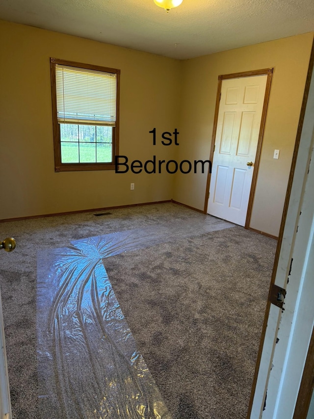 empty room with carpet floors and baseboards