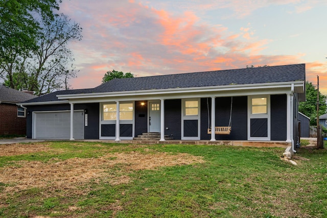 ranch-style house featuring covered porch, driveway, a front yard, brick siding, and an attached garage