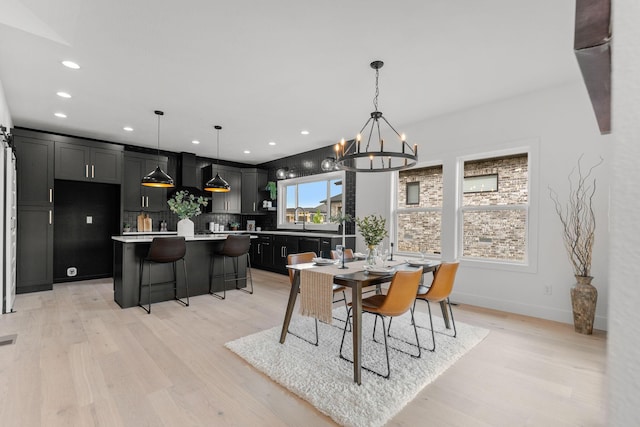 1822 E Cobblestone Dr, Ozark, MO 65721 - dining room featuring a chandelier, light wood-type flooring, recessed lighting, and baseboards