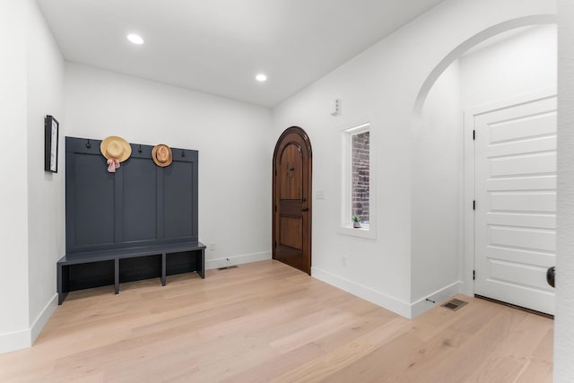 1822 E Cobblestone Dr, Ozark, MO 65721 - foyer entrance featuring light wood-style flooring, baseboards, recessed lighting, and arched walkways