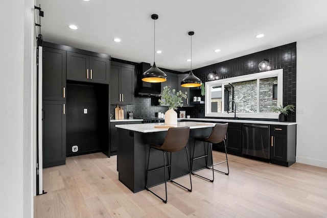 1822 E Cobblestone Dr, Ozark, MO 65721 - kitchen featuring dishwasher, light wood-style flooring, decorative backsplash, light countertops, and a breakfast bar
