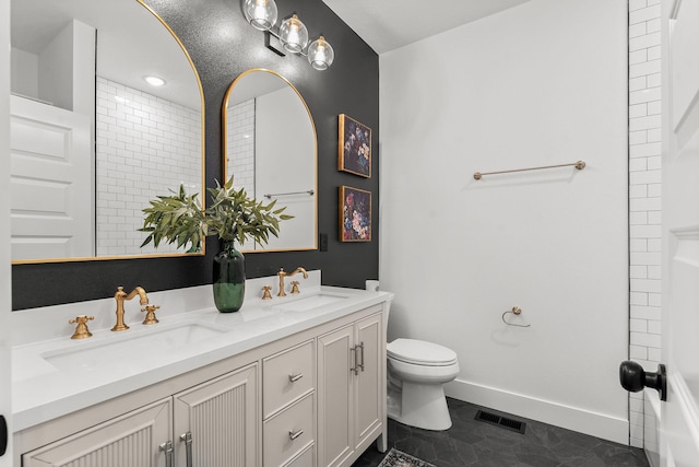 1822 E Cobblestone Dr, Ozark, MO 65721 - full bathroom featuring toilet, double vanity, and baseboards