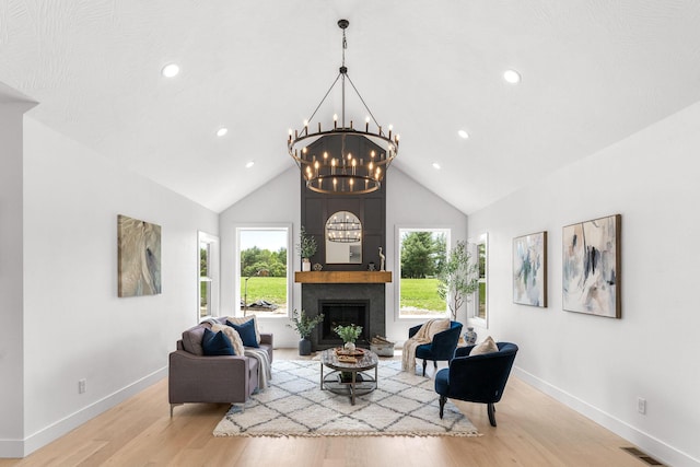 1822 E Cobblestone Dr, Ozark, MO 65721 - living room with baseboards, wood finished floors, a fireplace, a chandelier, and high vaulted ceiling