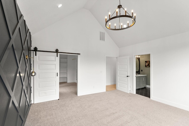 1822 E Cobblestone Dr, Ozark, MO 65721 - unfurnished bedroom with a barn door, carpet, high vaulted ceiling, a chandelier, and baseboards