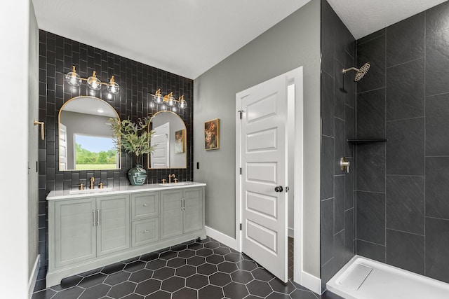 1822 E Cobblestone Dr, Ozark, MO 65721 - bathroom with double vanity, a tile shower, tile patterned floors, baseboards, and backsplash