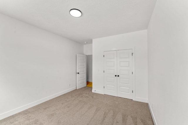 1822 E Cobblestone Dr, Ozark, MO 65721 - unfurnished bedroom featuring carpet, a closet, and baseboards