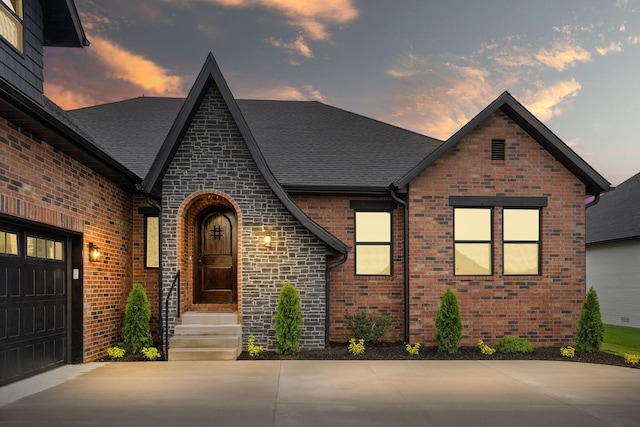 1822 E Cobblestone Dr, Ozark, MO 65721 - english style home with brick siding, driveway, and a shingled roof