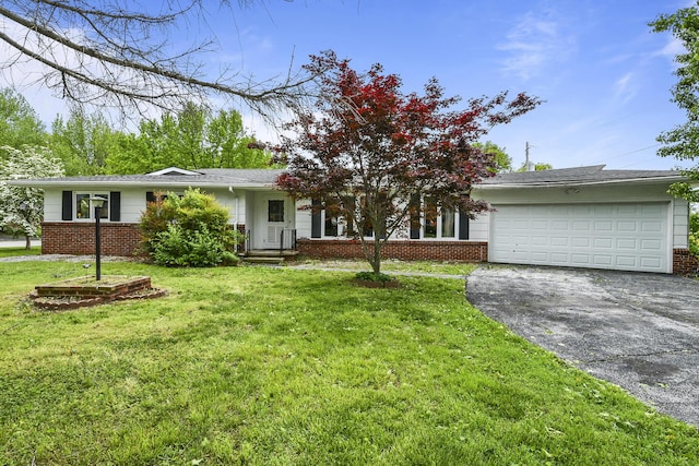 ranch-style house with brick siding, driveway, a front lawn, and a garage