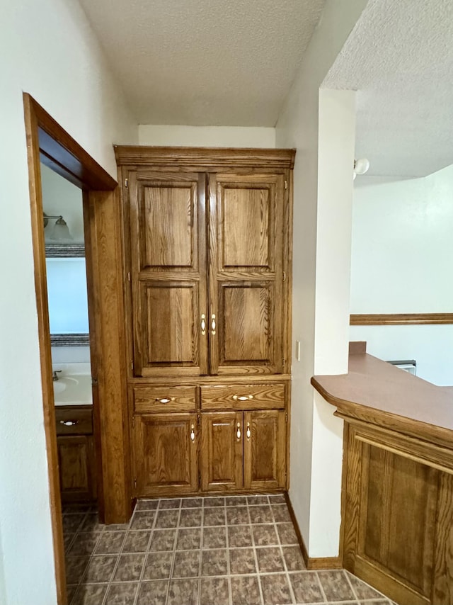details featuring baseboards and a textured ceiling