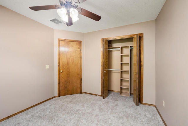 unfurnished bedroom with visible vents, carpet flooring, baseboards, and a closet