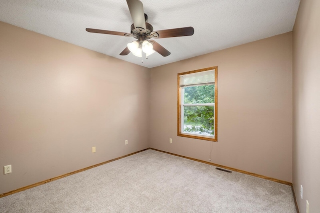 unfurnished room with visible vents, baseboards, and light colored carpet