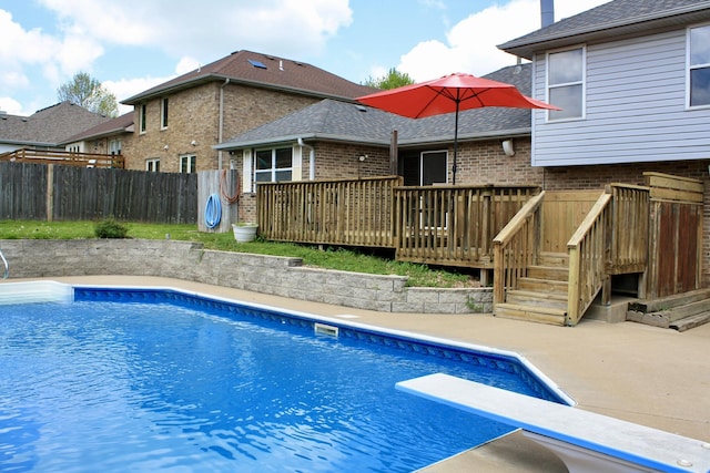 view of swimming pool with a fenced in pool, a fenced backyard, and a wooden deck