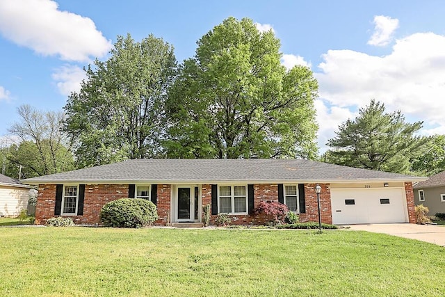 706 W Katella Ct, Springfield, MO 65807 - ranch-style home with brick siding, an attached garage, driveway, and a front lawn