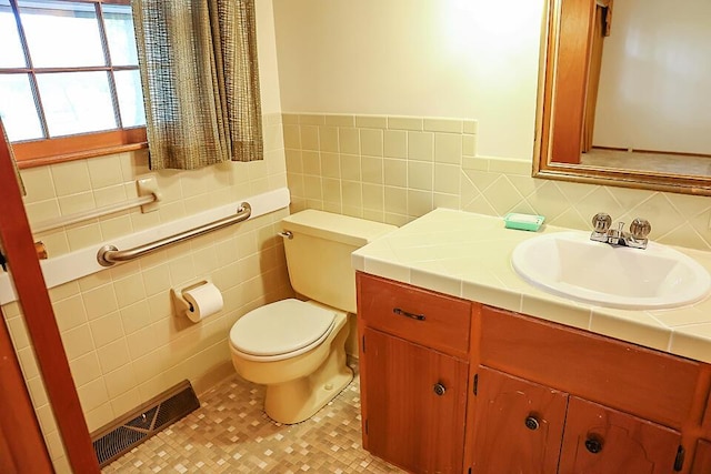 706 W Katella Ct, Springfield, MO 65807 - bathroom with visible vents, vanity, toilet, and tile walls