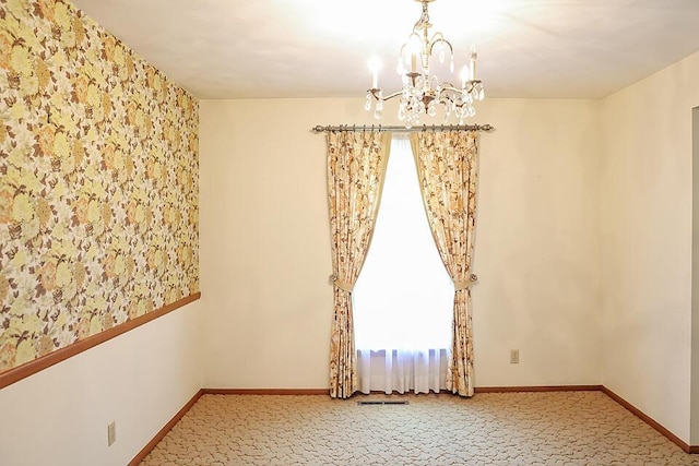 706 W Katella Ct, Springfield, MO 65807 - empty room with baseboards, carpet, and a notable chandelier