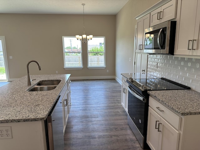 kitchen featuring a sink, a chandelier, dark wood finished floors, stainless steel appliances, and tasteful backsplash