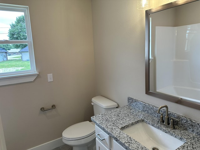 bathroom featuring vanity, baseboards, walk in shower, and toilet