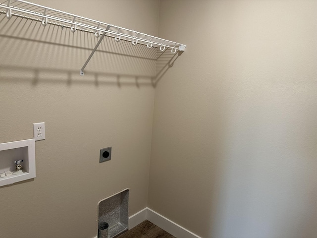 laundry room with laundry area, hookup for a washing machine, electric dryer hookup, baseboards, and dark wood-type flooring