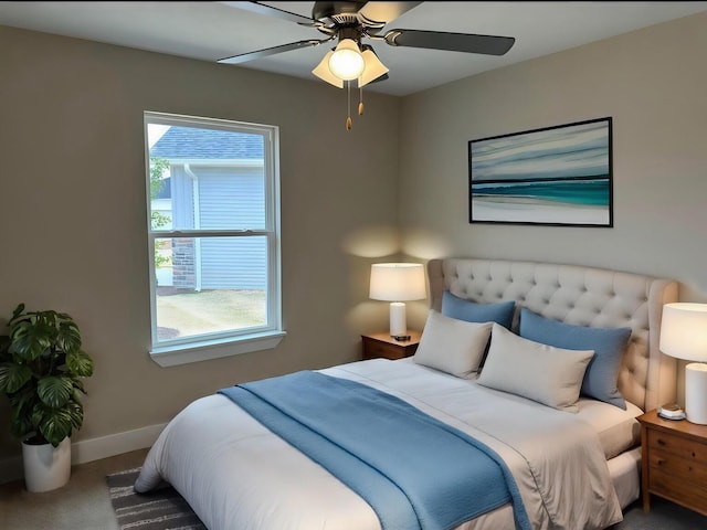 carpeted bedroom with a ceiling fan and baseboards