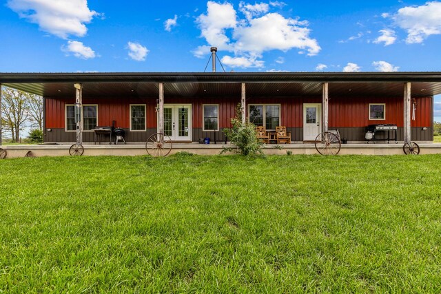 back of property featuring a yard, a patio, and french doors