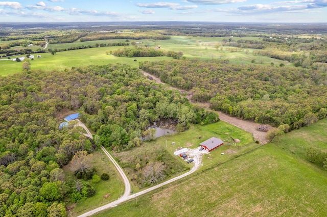 drone / aerial view featuring a rural view and a wooded view