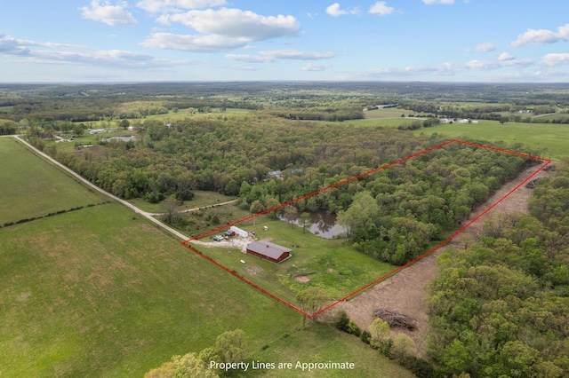 aerial view with a wooded view and a rural view