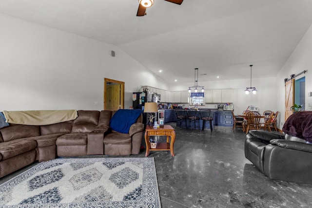 living room with vaulted ceiling, a ceiling fan, concrete flooring, and a barn door