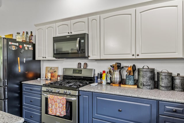 kitchen with white cabinets, black appliances, and blue cabinets
