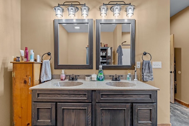 full bathroom featuring double vanity and a sink