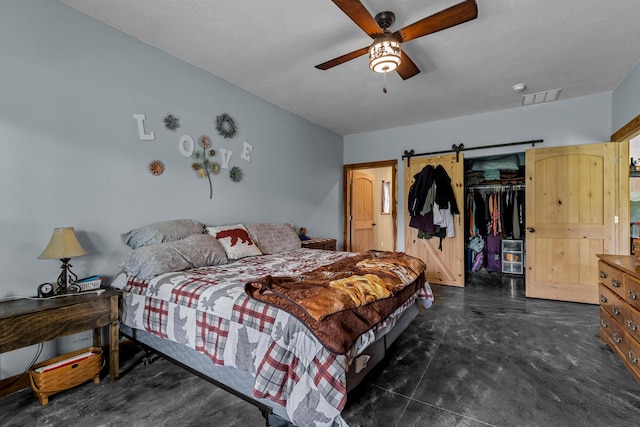 bedroom featuring a walk in closet, ceiling fan, a closet, and visible vents