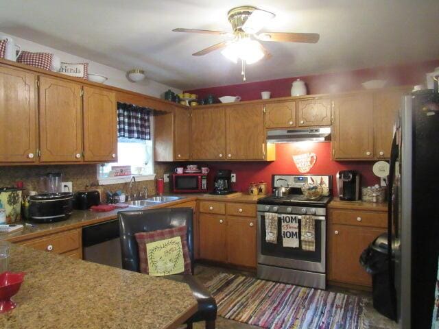 7210 Newkirk Rd, Mountain Grove, MO 65711 - kitchen featuring a sink, under cabinet range hood, ceiling fan, light countertops, and appliances with stainless steel finishes