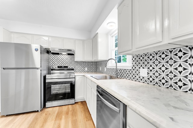 1107 E Mccracken Rd, Ozark, MO 65721 - kitchen featuring a sink, stainless steel appliances, under cabinet range hood, light wood finished floors, and white cabinetry