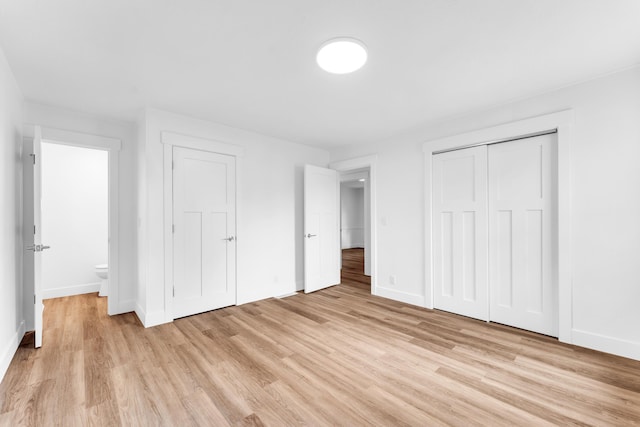 1107 E Mccracken Rd, Ozark, MO 65721 - unfurnished bedroom with light wood-style flooring and baseboards
