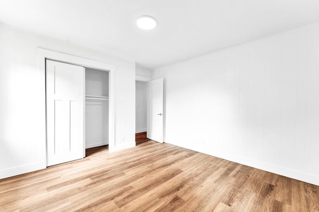 1107 E Mccracken Rd, Ozark, MO 65721 - unfurnished bedroom featuring light wood finished floors, a closet, and baseboards