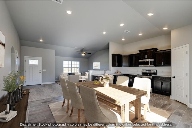 dining room with recessed lighting, a ceiling fan, lofted ceiling, and wood finish floors