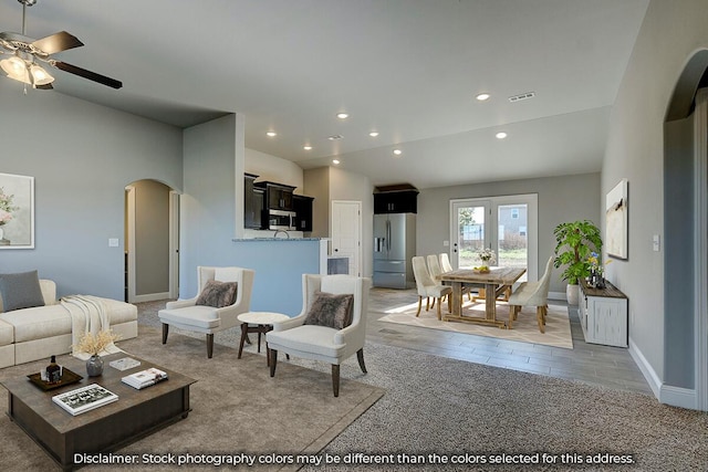 living room featuring ceiling fan, arched walkways, recessed lighting, baseboards, and visible vents