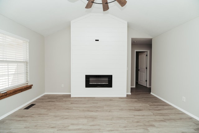 unfurnished living room featuring visible vents, a ceiling fan, vaulted ceiling, and light wood-type flooring