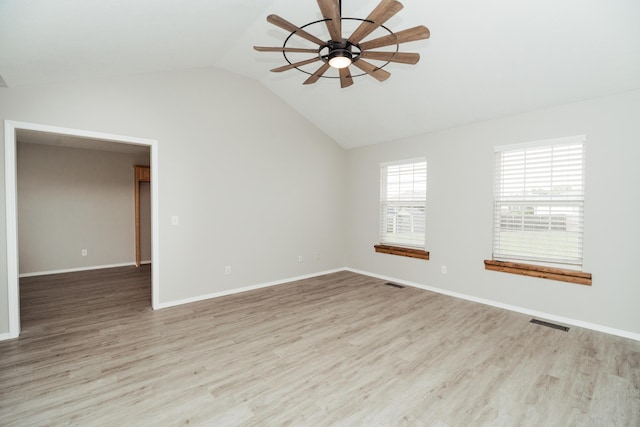 unfurnished room featuring a ceiling fan, visible vents, light wood finished floors, and lofted ceiling