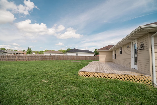 view of yard with fence and a wooden deck