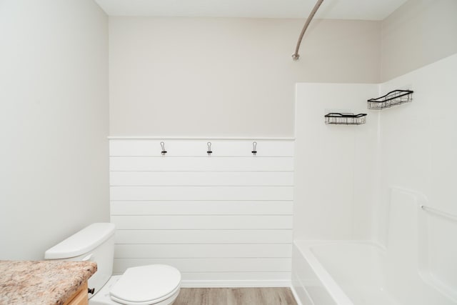 bathroom featuring wood finished floors and toilet