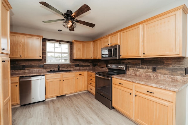 kitchen with decorative backsplash, light brown cabinetry, a sink, light wood-style flooring, and stainless steel appliances