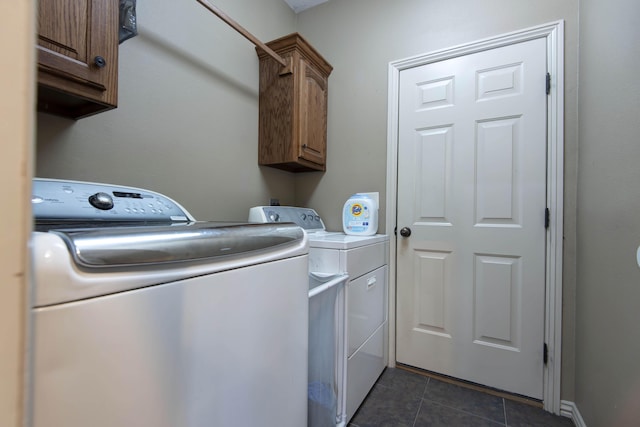 1376 N 14th St, Ozark, MO 65721 - clothes washing area featuring washer and dryer, dark tile patterned floors, and cabinet space