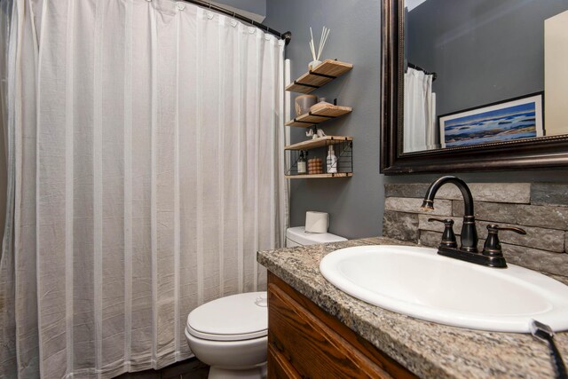 1376 N 14th St, Ozark, MO 65721 - full bath with vanity, decorative backsplash, and toilet